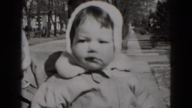 1949: mother holding child posing for the camera