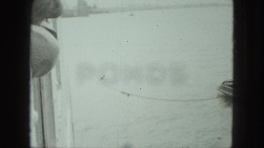 1949: tugboat slowly pulling larger boat away from dock VENICE, ITALY