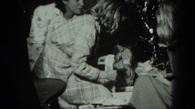 1949: girl open confusing christmas present in her robe VENICE, ITALY