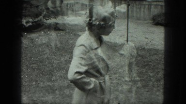 1949: little girl holding cat resists allowing her friend to pet the creature