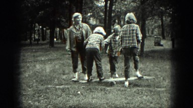 1949: group of girls play in and around the clearing of wooded area. VENICE