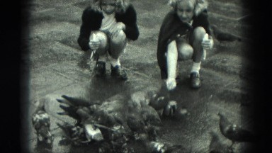 1949: girls in city feeding pigeons VENICE, ITALY