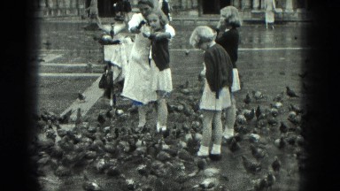 1949: school girls in uniform enjoy feeding flock of pigeons