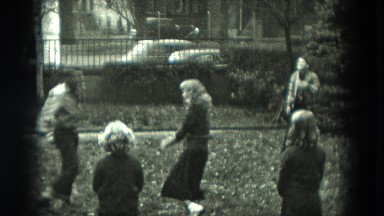 1951: five young people play keep away with ball in the front yard GERMANY