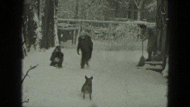 1951: Children Playing in Snow Near House and Garage in Germany