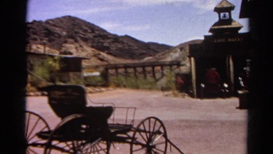 1966: horse drawn carriage set against western mountain town CALIFORNIA