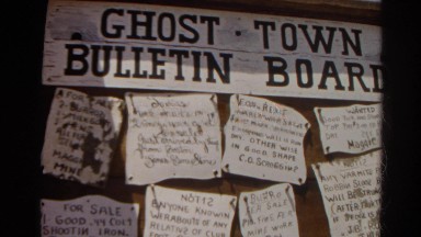 1966: ghost town bulletin board loaded with written notices CALIFORNIA