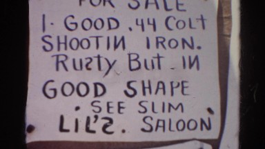 1966: ghost town bulletin board loaded with written notices CALIFORNIA