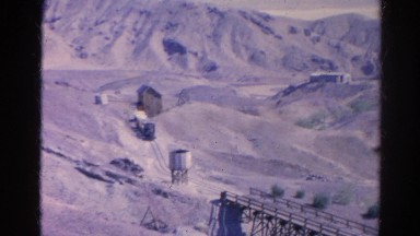 1966: rocky mining area dry desert town railroad train riding elevated tracks
