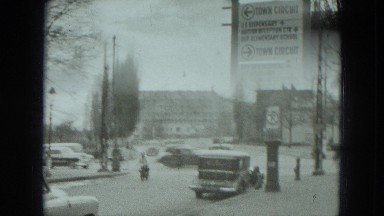 1951: people walking down the street in what seems to be busy town