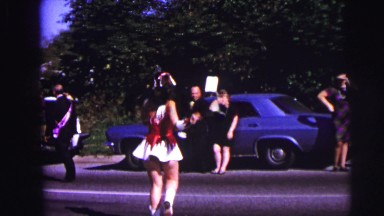 1973: Dancer Twirling Baton in Parade While Being Watched by Onlookers Lynbrook