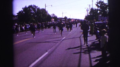1973: Parade of Children Walking Down Street Twirling Batons and Celebrating