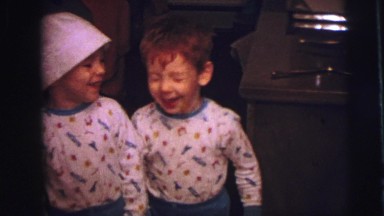 1973: twin brothers wearing matching pajamas smile happy as clams LYNBROOK