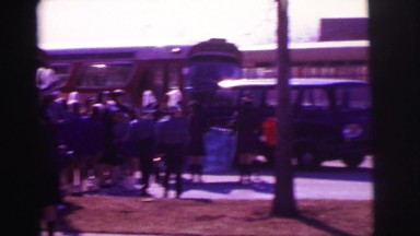 1974: students walking around bus with instruments LYNBROOK, NEW YORK