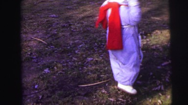 1974: Excited Toddler Dressed Warmly Twirling Outdoors on Cool Fall Day in Lynbrook