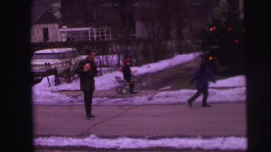 1974: father playing ball in the middle of the street with his children