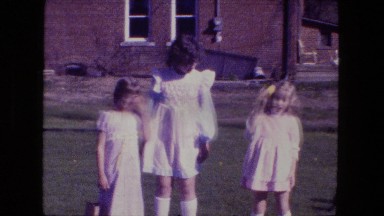 1976: three little girls standing outdoor with easter eggs FORT WAYNE, INDIANA