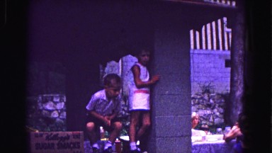 1971: kid riding on dad's shoulders across at picnic at the family park OMAHA