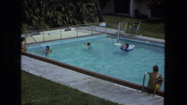 1976: hotel swimming pool area child dives underwater practicing her breathing