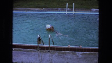 1976: children swimming with ball in swimming pool FORT WAYNE, INDIANA