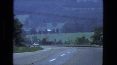 1976: countryside motorist views hills trees and valleys while driving
