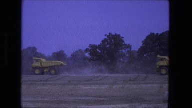 1976: vehicles speeding along dirt road around work site. FORT WAYNE, INDIANA