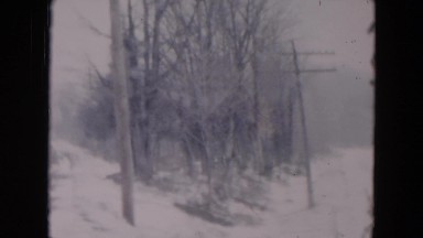 1957: desolate snow covered road during winter storm HICKSVILLE, NEW YORK