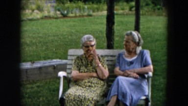 1957: two old women and young woman in meeting of women outdoors, the old women