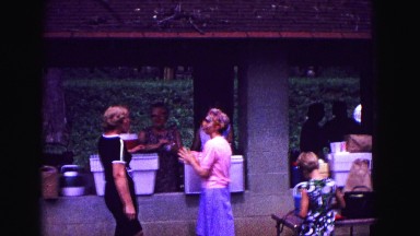 1971: people talking at hut during community gathering OMAHA, NEBRASKA