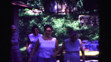 1971: ladies gather to talk and laugh at family reunion under covered picnic