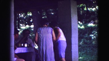 1971: family reunion picnic eating at tables outdoors OMAHA, NEBRASKA
