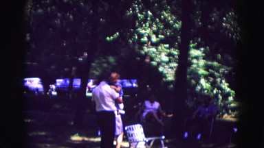 1971: dad carries child through the picnic OMAHA, NEBRASKA