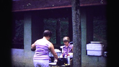 1971: mother daughter cooking food wrapping hotdogs picnic eats OMAHA, NEBRASKA