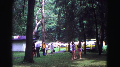 1971: families walking toward picnic area at park while talking and visiting