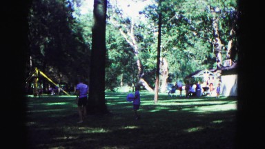 1971: boy with blue ball walking with other kids at recreational area OMAHA