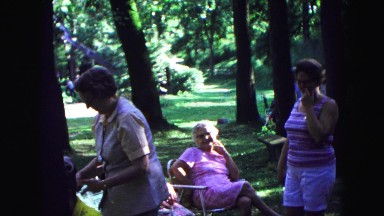 1971: ladies chatting joking with one another at relaxing outdoor park