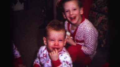 1973: Christmas Tree with Child Opening Presents in Lynbrook, New York