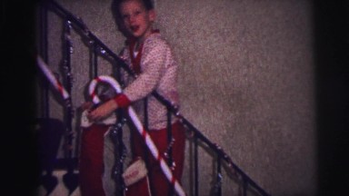 1973: Boy in Pajamas Happily Hangs Stocking for Santa on Christmas Eve