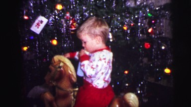 1973: child is sitting on toy while sucking on an object LYNBROOK, NEW YORK