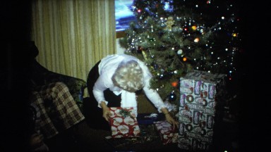 1974: family sorting presents near christmas tree FORT WAYNE, INDIANA
