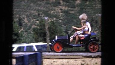 1974: woman and young girl driving small electric car FORT WAYNE, INDIANA