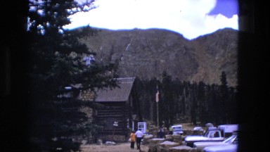 1974: cars are parked in parking lot outdoor cabin in the mountains. FORT WAYNE