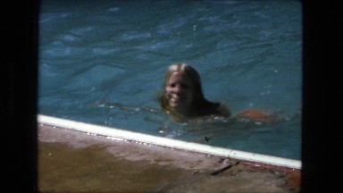 1974: cute blonde girl swimming in pool summer funtime party FORT WAYNE, INDIANA