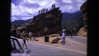 1974: people roaming rock formations showing interest in the place around them