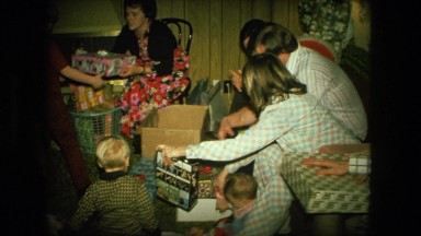 1974: family unwrapping christmas presents FORT WAYNE, INDIANA