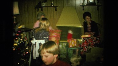 1974: christmas tree is seen with child opening presents FORT WAYNE, INDIANA