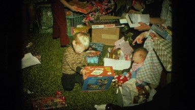 1974: cute blonde boy child unwrapping xmas gifts FORT WAYNE, INDIANA