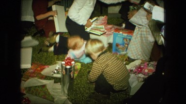 1974: christmas tree is seen with child opening presents FORT WAYNE, INDIANA