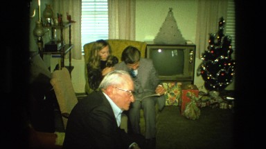 1974: christmas tree is seen with child opening presents FORT WAYNE, INDIANA
