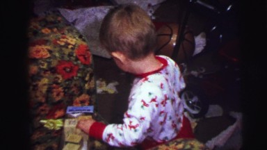 1973: christmas tree is seen with child opening presents LYNBROOK, NEW YORK